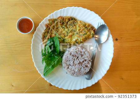 Mince pork omelet with rice on white dish Mince pork omelet with rice on white dish 92351373