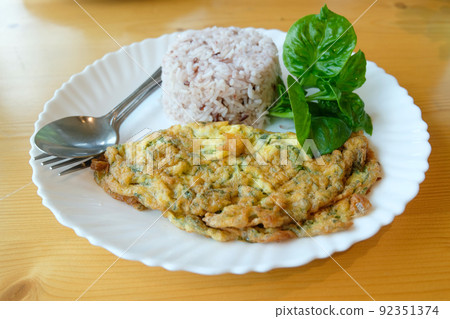 Mince pork omelet with rice on white dish Mince pork omelet with rice on white dish 92351374