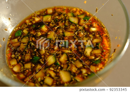 Soy sauce in a glass bowl with some vegetables. Soy sauce in a glass bowl with some vegetables. 92353345