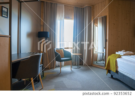 Interior of cozy rustic style bedroom in luxurious resort during sunny day 92353652