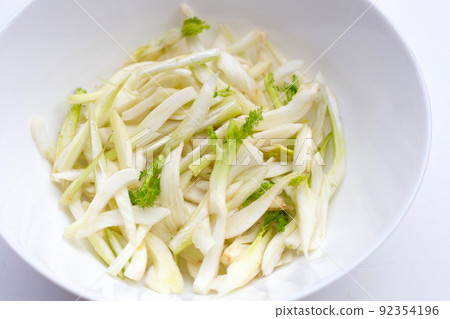 Sliced fresh fennel in white bowl on white background. Sliced fresh fennel in white bowl on white background. 92354196