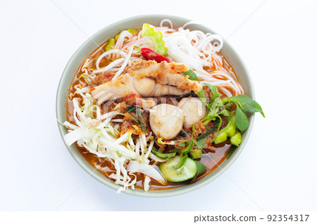 Thai rice noodle with chicken feet curry and fish balls Thai rice noodle with chicken feet curry and fish balls 92354317