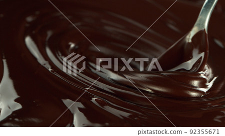 Close-up of stirring stream of melted chocolate. 92355671