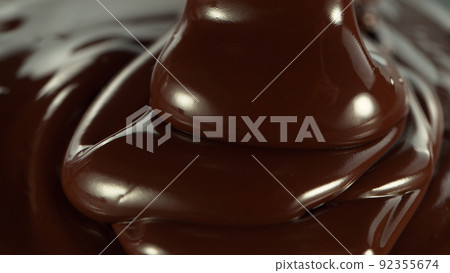Close-up of pouring stream of melted chocolate. 92355674
