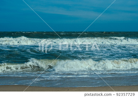 Ocean storm waves dramatically crashing splashing. Sky horizon line. Sea water edge, nature front view marine wallpaper. Bad weather cloudy overcast. Dark green turquoise blue bright vivid contrast Ocean storm waves dramatically crashing splashing. Sky horizon line. Sea water edge, nature front view marine wallpaper. Bad weather cloudy overcast. Dark green turquoise blue bright vivid contrast 92357729