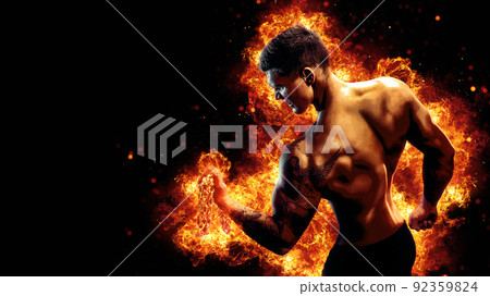 Body builder with fit torso belly chest and arms biceps triceps muscles holding chain while posing over the black background with fire. Bodybuilding concept  92359824