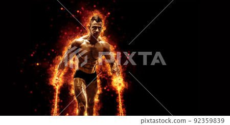 Body builder with fit torso belly chest and arms biceps triceps muscles holding chain while posing over the black background with fire. Bodybuilding concept  92359839