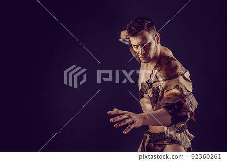 Portrait of handsome muscular gladiator with sword. Isolated. Studio shot.  92360261