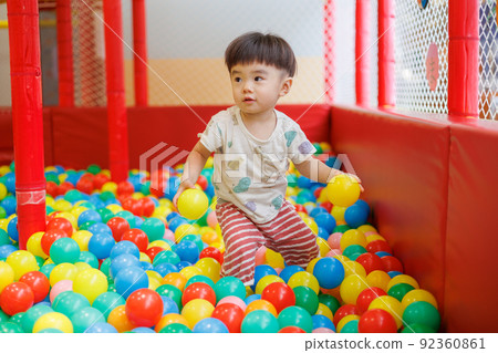 Boy playing in the ball pool 92360861