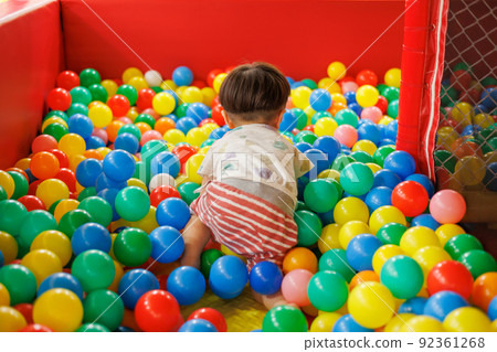 Boy playing in the ball pool 92361268