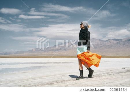 asian woman female tourist in long skirt walking on saline alkali land asian woman female tourist in long skirt walking on saline alkali land 92361384