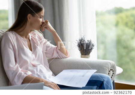 Sad woman get bank notification feels desperate looks frustrated 92362170