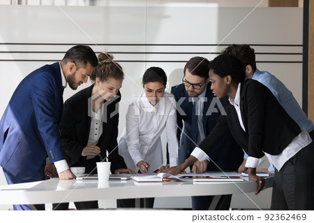 Multiethnic millennial business group of employees discussing project Multiethnic millennial business group of employees discussing project 92362469