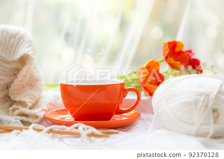 Coffee morning.  Yellow steaming cup of hot coffee for relax after working hobbies crochet 92370128