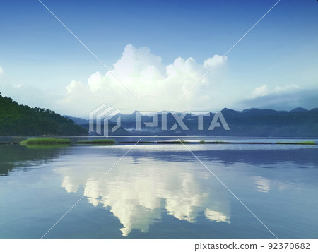 Beautiful natural scenery of river in southeast Asia tropical green forest with mountains in background Beautiful natural scenery of river in southeast Asia tropical green forest with mountains in background 92370682