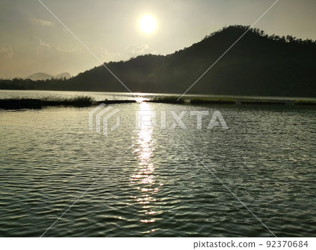 Beautiful landscape above clouds and mountains with sun rising in the middle Beautiful landscape above clouds and mountains with sun rising in the middle 92370684