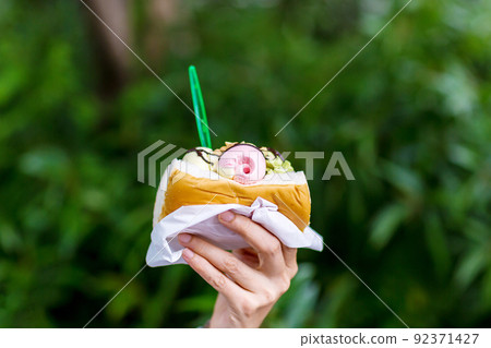 The scoops of ice cream are put in the bread. The scoops of ice cream are put in the bread. 92371427