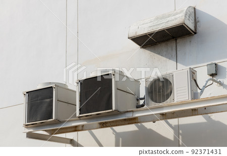 Air conditioner compressor installed in old building. Air conditioner compressor installed in old building. 92371431