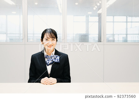 Business woman with a ribbon scarf (bank clerk, window, hotelier) 92373560