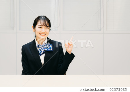 Business woman with a ribbon scarf (pointing) 92373985