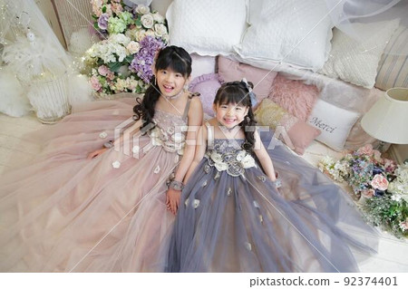 Smile sisters wearing dresses and looking up Smile sisters wearing dresses and looking up 92374401