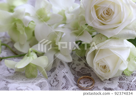 Pure white rose and wedding ring Pure white rose and wedding ring 92374834