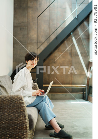 A woman teleworking in a fashionable living room 92379981