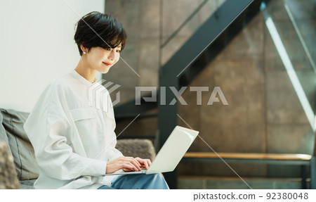A woman teleworking in a fashionable living room 92380048