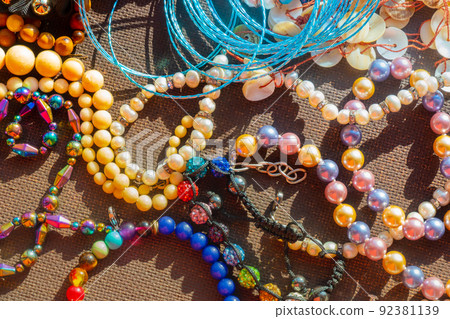 a lot of costume jewelry with different materials on a black background a lot of costume jewelry with different materials on a black background 92381139