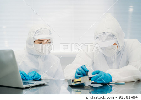 Female handling precision equipment in a clean room 92381484