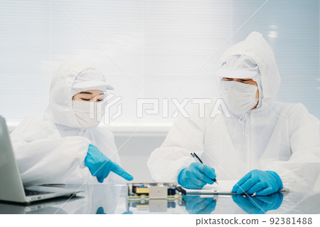 Female handling precision equipment in a clean room 92381488