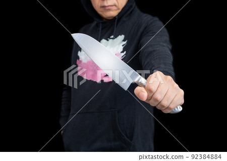 Person with a kitchen knife Person with a kitchen knife 92384884