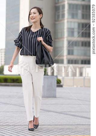 businesswoman walking in office businesswoman walking in office 92385079
