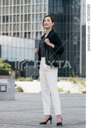businesswoman walking in office businesswoman walking in office 92385080