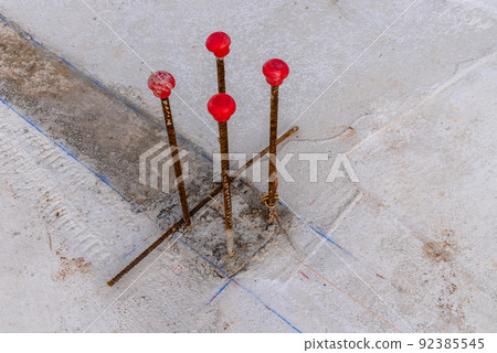 Pillar rebars with plastic capsin construction site 92385545