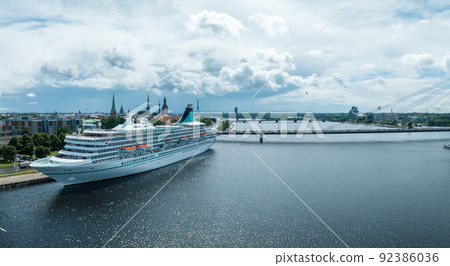 Beautiful cruise ship docked in Riga, Latvia near the old town and the bridge. Beautiful cruise ship docked in Riga, Latvia near the old town and the bridge. 92386036