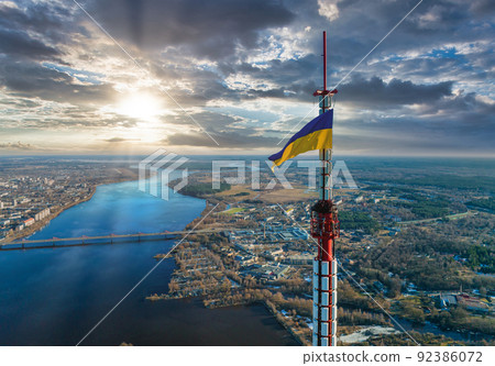 Aerial view of the Ukrainian flag waving on top of the Riga TV Tower 92386072