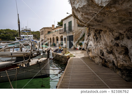 Sailboats moored by pier at harbor in city against clear blue sky Sailboats moored by pier at harbor in city against clear blue sky 92386762