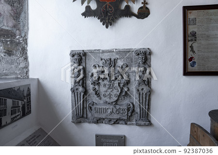 Carved structure with photographs and frames at old pharmacy museum in historic town 92387036