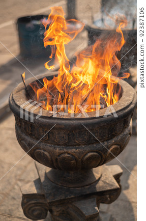 Burning incense sticks in old stone pot at Sacred Sri Maha Bhodi Gardens. Burning incense sticks in old stone pot at Sacred Sri Maha Bhodi Gardens. 92387106