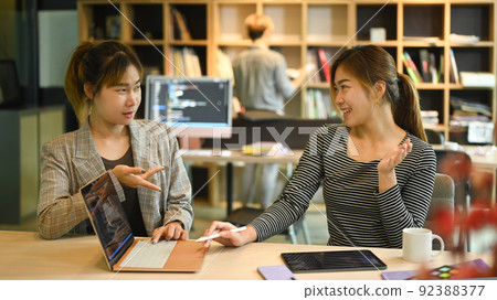 Two young female software programmer or coder discussing detail of project developing website design and coding technologies Two young female software programmer or coder discussing detail of project developing website design and coding technologies 92388377