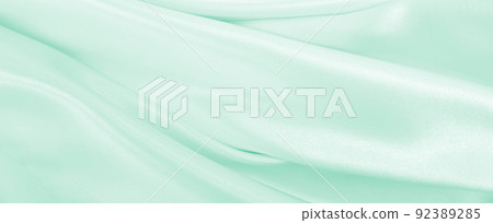Smooth elegant green silk or satin luxury cloth texture as abstract background. Luxurious background design Smooth elegant green silk or satin luxury cloth texture as abstract background. Luxurious background design 92389285