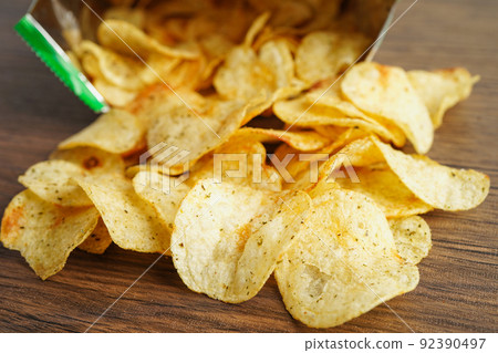 Potato chips in open bag, delicious BBQ seasoning spicy for crips, thin slice deep fried snack fast food in open bag. 92390497