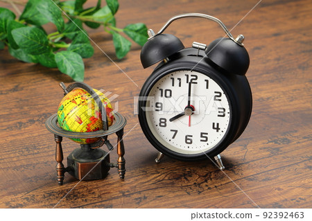 Alarm clock and globe time difference image Alarm clock and globe time difference image 92392463