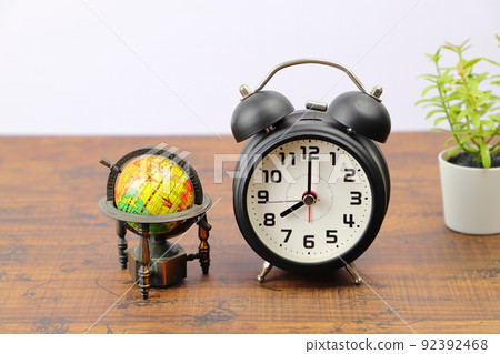 Alarm clock and globe time difference image 92392468