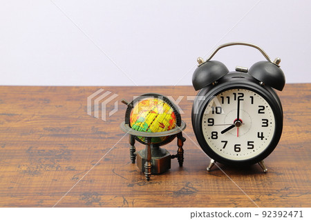 Alarm clock and globe time difference image Alarm clock and globe time difference image 92392471