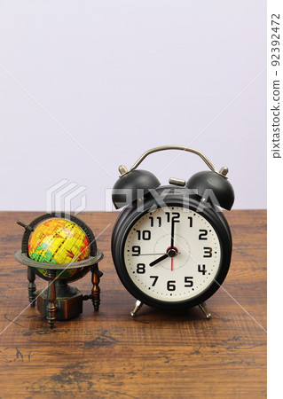 Alarm clock and globe time difference image vertical 92392472