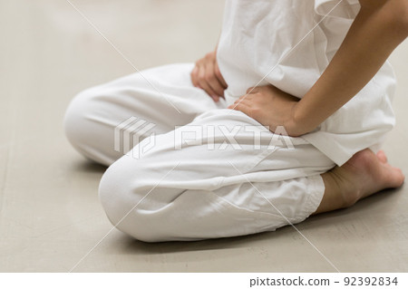 An elementary school girl practicing karate in a summer classroom 92392834