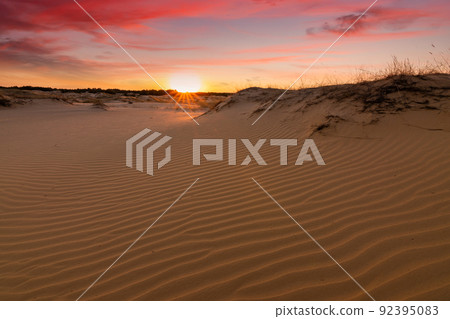 Sunset over the sand dunes in the desert. Arid landscape of the Sahara desert. 92395083