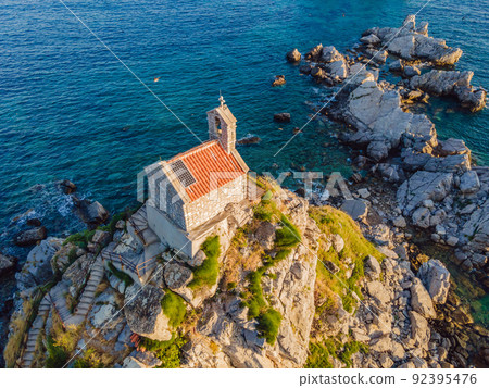 Sveta Nedelja is an islet on the Adriatic Sea, in Montenegrin municipality of Budva. It is located opposite the town of Petrovac na Moru in Montenegro. It has a small church on it Portrait of a Sveta Nedelja is an islet on the Adriatic Sea, in Montenegrin municipality of Budva. It is located opposite the town of Petrovac na Moru in Montenegro. It has a small church on it Portrait of a 92395476